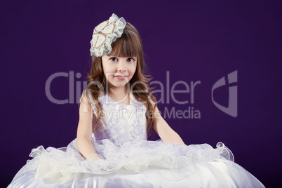 Image of cute little girl posing in white dress