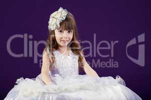 Image of cute little girl posing in white dress