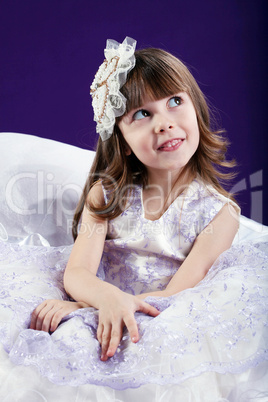 Charming little girl posing in studio
