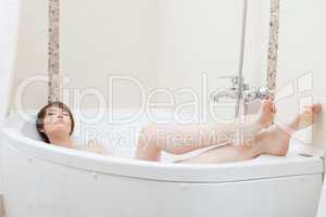 Slim beautiful brunette posing in bath