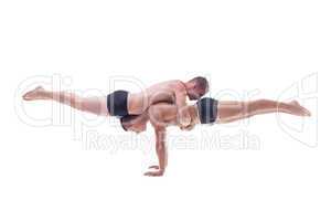 Muscled acrobats keep balance