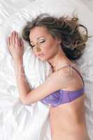 Sweet brunette sleeping in purple lingerie