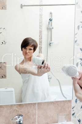 Playful girl posing with hair dryer