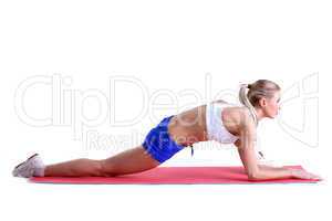 Sporty woman doing stretching exercises on mat