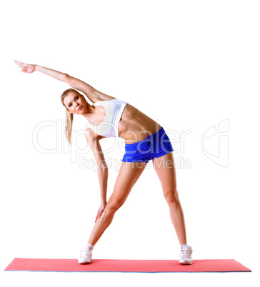 Beautiful woman practices aerobics in studio