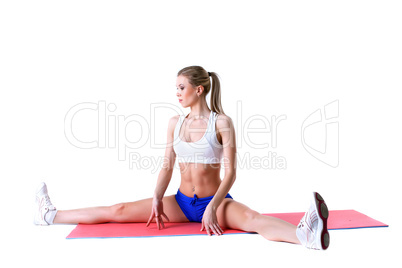 Athletic woman practices aerobics on mat