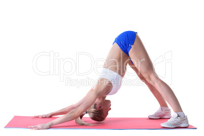 Flexible woman doing stretching exercises on mat