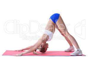 Flexible woman doing stretching exercises on mat