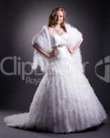 Pretty woman posing in luxurious wedding dress