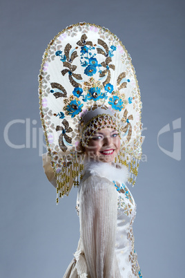 Portrait of smiling young woman in kokoshnik