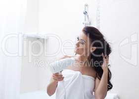 Beautiful woman posing with hairdryer in bathroom