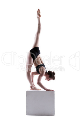 Beautiful girl posing doing exercises on cube