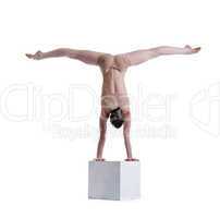 Flexible woman posing doing exercises on cube