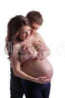 Topless man and pregnant woman posing in studio