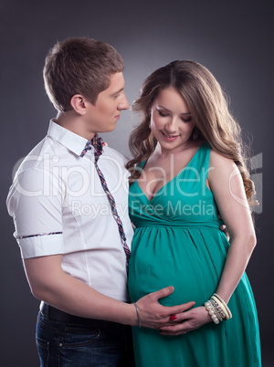 Handsome man with charming pregnant woman