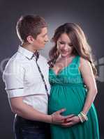 Handsome man with charming pregnant woman
