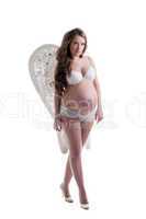 Charming pregnant woman posing in lingerie