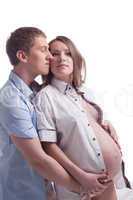 Young man hugging pretty pregnant woman