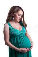 Beautiful pregnant woman posing in green dress