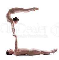 Image of two young acrobats balancing in studio