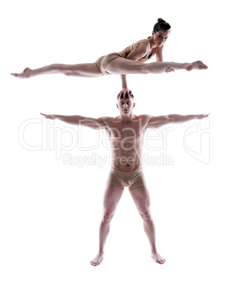Two flexible gymnasts posing in studio