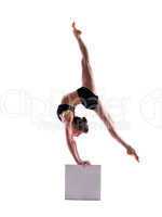 Flexible sporty girl posing on cube
