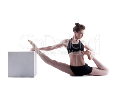 Beautiful girl doing stretching in studio