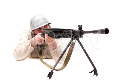 Soldier with rifle posing in studio, close-up