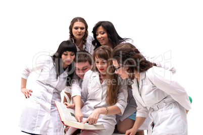 Young physicians posing looking in book