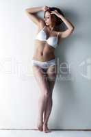 Young slim model posing in erotic lingerie