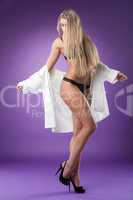 Sexy blonde with long hair posing in studio