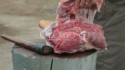 Street vendor cutting pork meat