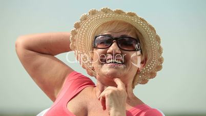 Face of happy senior woman outdoors