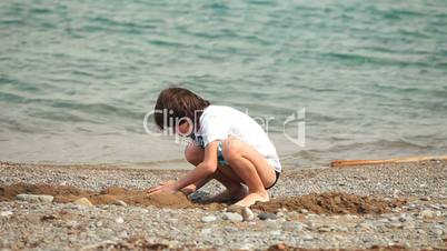 Child playing on the summer beach