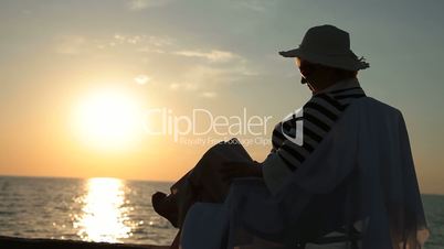 Silhouette of senior woman by the sea