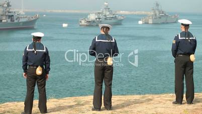 Sailors looking at navy ships