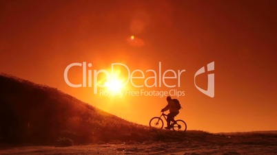 Mountain Biker Silhouette At Sunrise