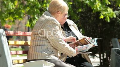 Senior Women Reading Magazines In The Park