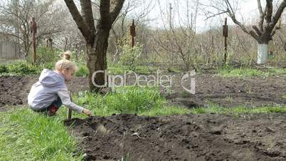 Little Girl Planting Peas on Smallholder Farm