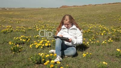 Child Using a Touch Screen Tablet PC Outdoors