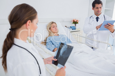 Doctors with xray and digital tablet