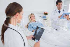 Doctors with xray and digital tablet