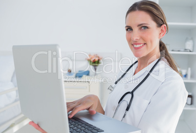 Woman doctor using laptop