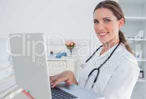 Woman doctor using laptop