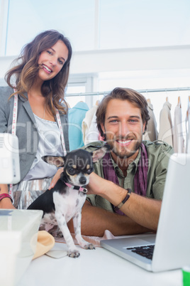 Two fashion designers smiling to the camera