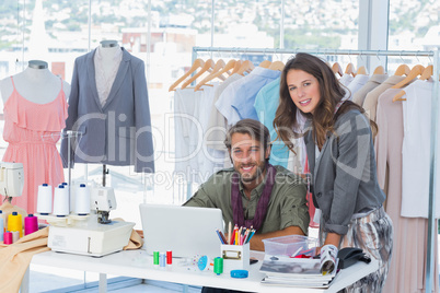 Two fashion designers looking at camera