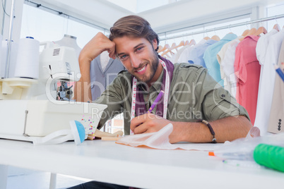 Happy designer working at his desk