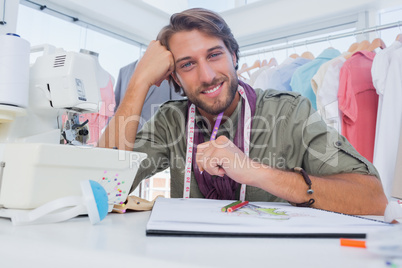 Smiling designer working at his desk