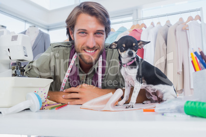 Fashion designer looking at camera with his chihuahua