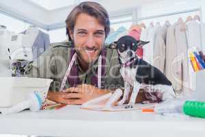 Fashion designer looking at camera with his chihuahua